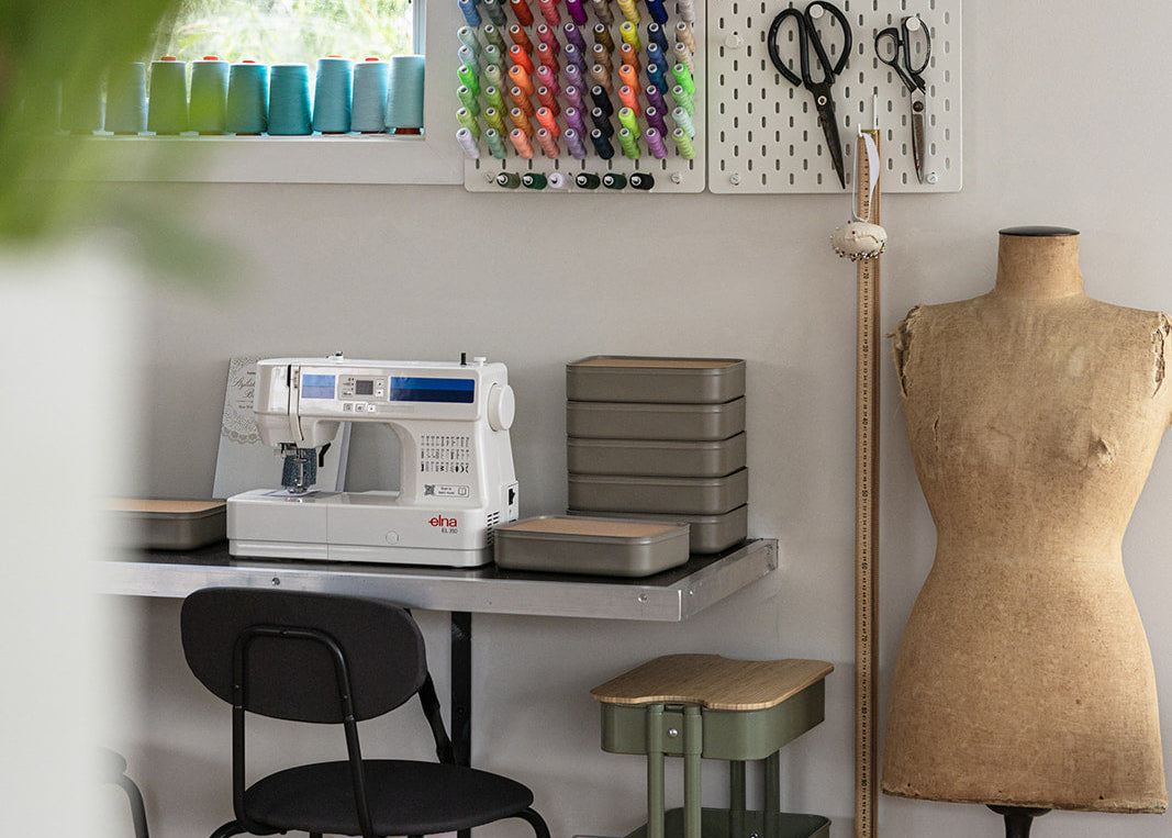 Craft room with sewing machine, pegboard with tools, and mannequin.